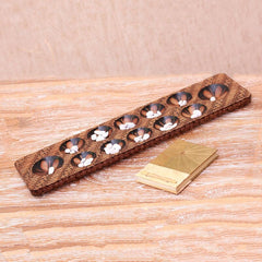 Batik Wood Game Five to Seven Stones and The Game is Played in Turns. Similar to Mancala, Each Player Collects the Stones From One Hole