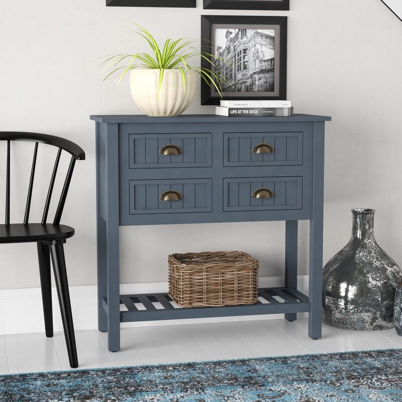 Console Table  Curated Displays of Family Photos, Potted Plants, and More Four Paneled Drawers with Cup Pulls and Boasts A Solid Color