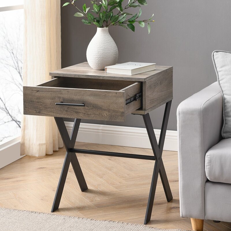 Gray Wash Cross Legs End Table with Storage Tuck Away your Favorite in Its Single Drawer Or Purchase Two To Frame your Comfiest Armchair