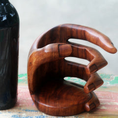Solid Wood Tabletop Wine Bottle Rack in Brown Embraces A Bottle of Wine